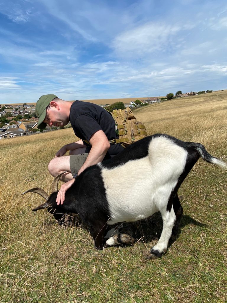 Photo of James and a goat